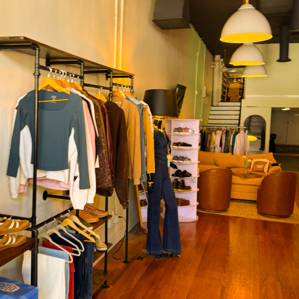 a rack of clothes and a seating area